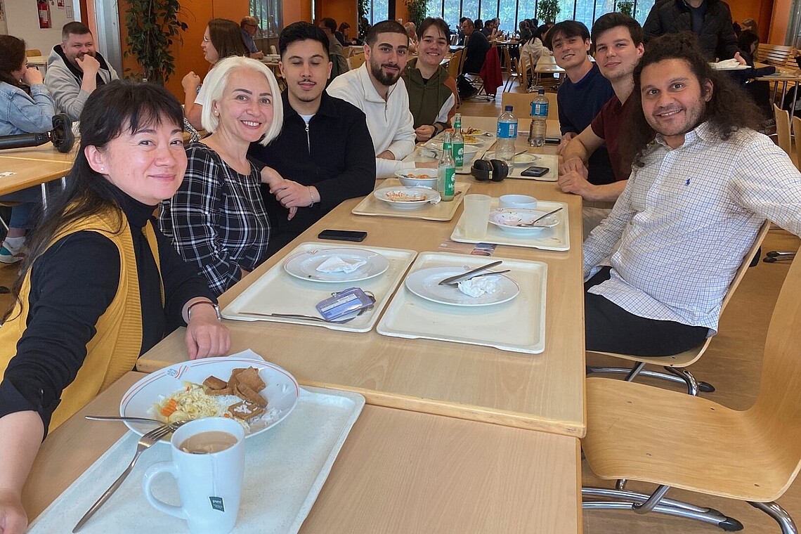 Group of professors and students at a cafeteria table