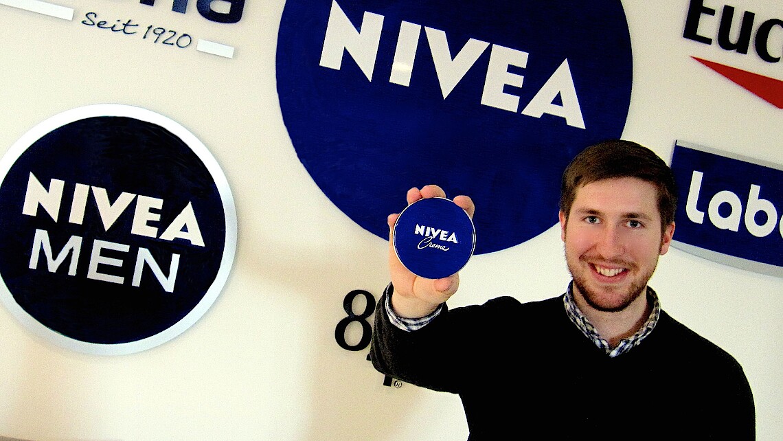 Male student holding a Nivea cream