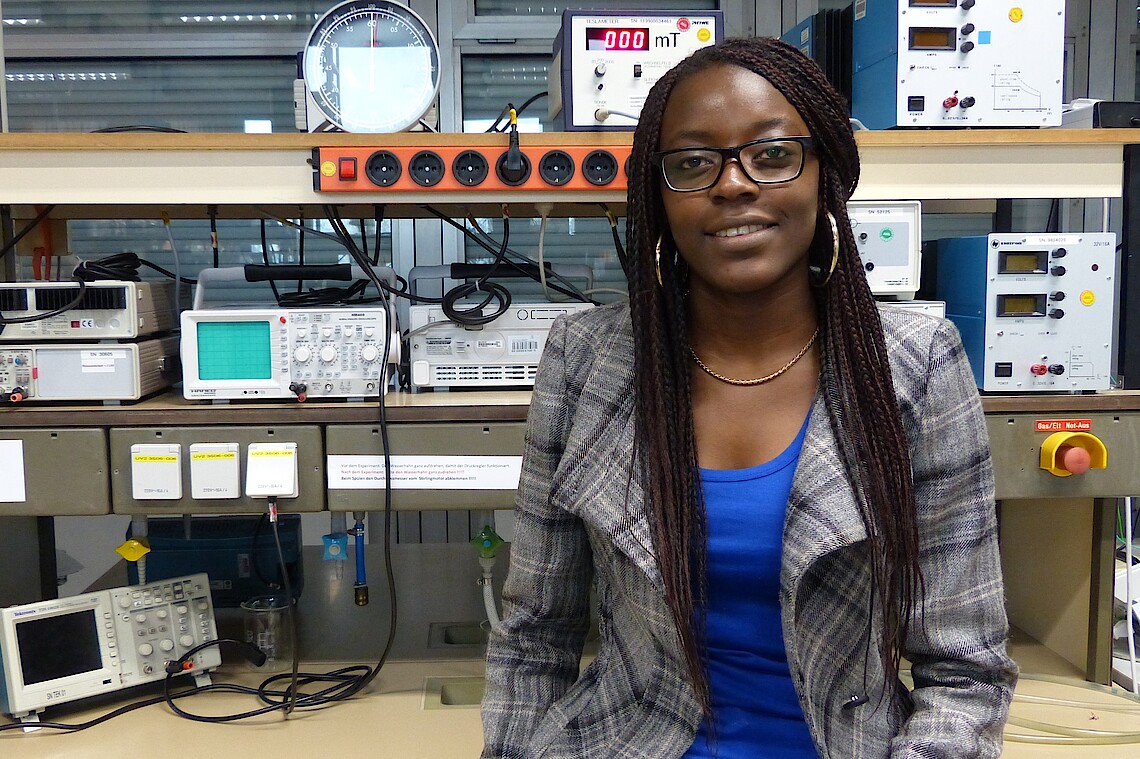 African female student sitting in a process engineering lab