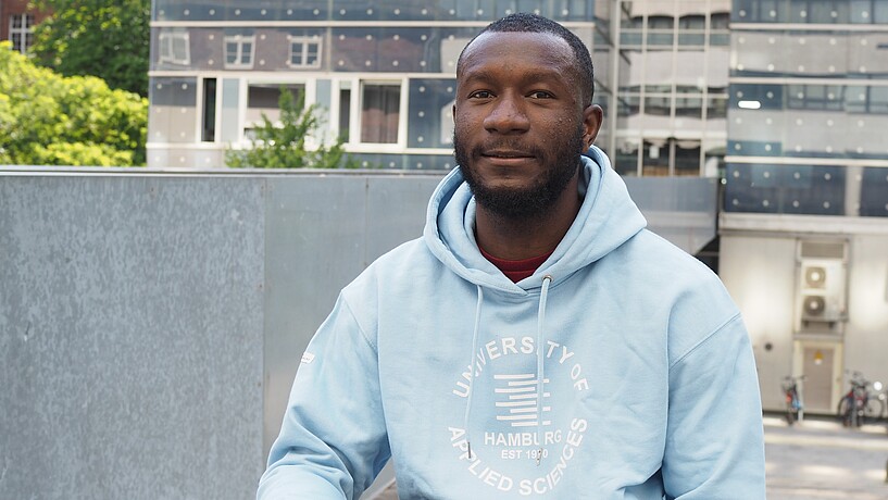 Male student in front of a university building