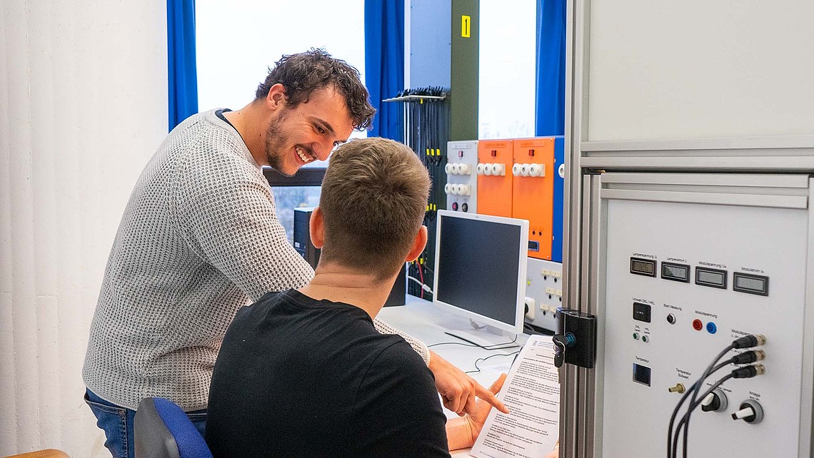 Zwei Studierende lesen eine Laboranleitung