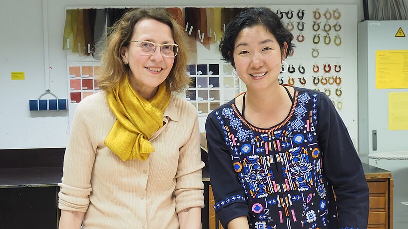 Two female professors looking into the camera