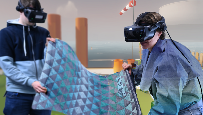 zwei Menschen mit VR-Brille halten eine Decke