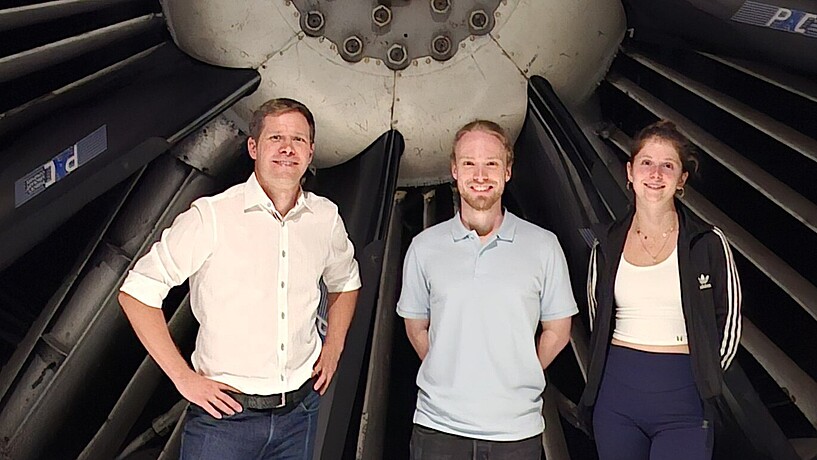 Professor with two students in a wind tunnel