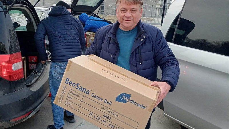 Artur Kovalenko von der HAW Hamburg mit einem Karton mit Hilfsgütern