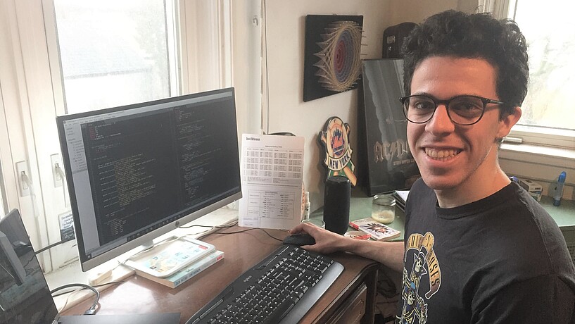 Male student in front of a computer