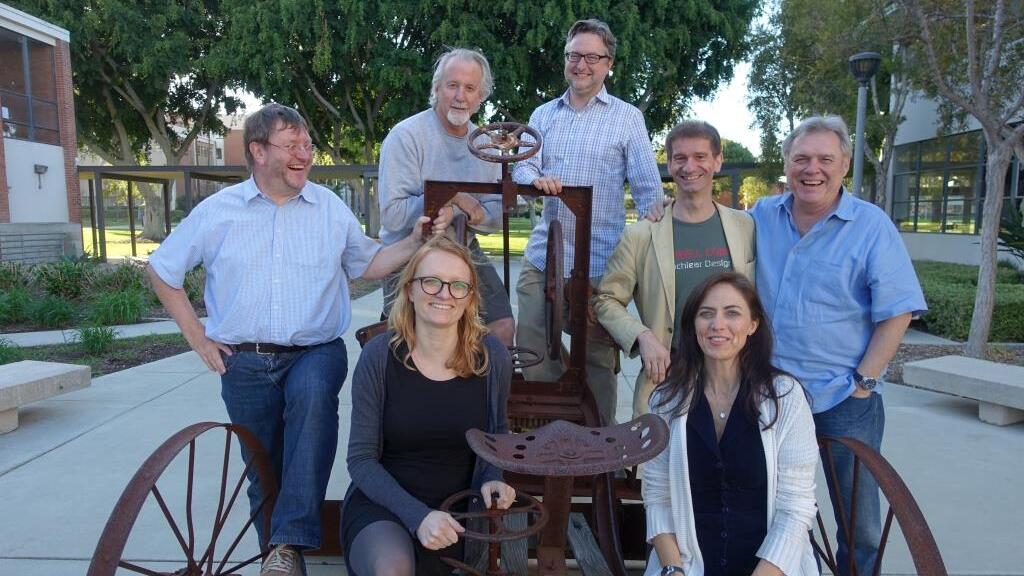 Group of professors laughing into the camera