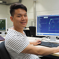 Male student sitting in front of a computer