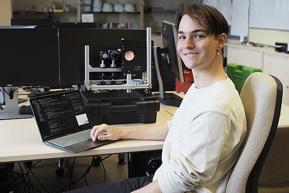 Male student with lap top in a research lab