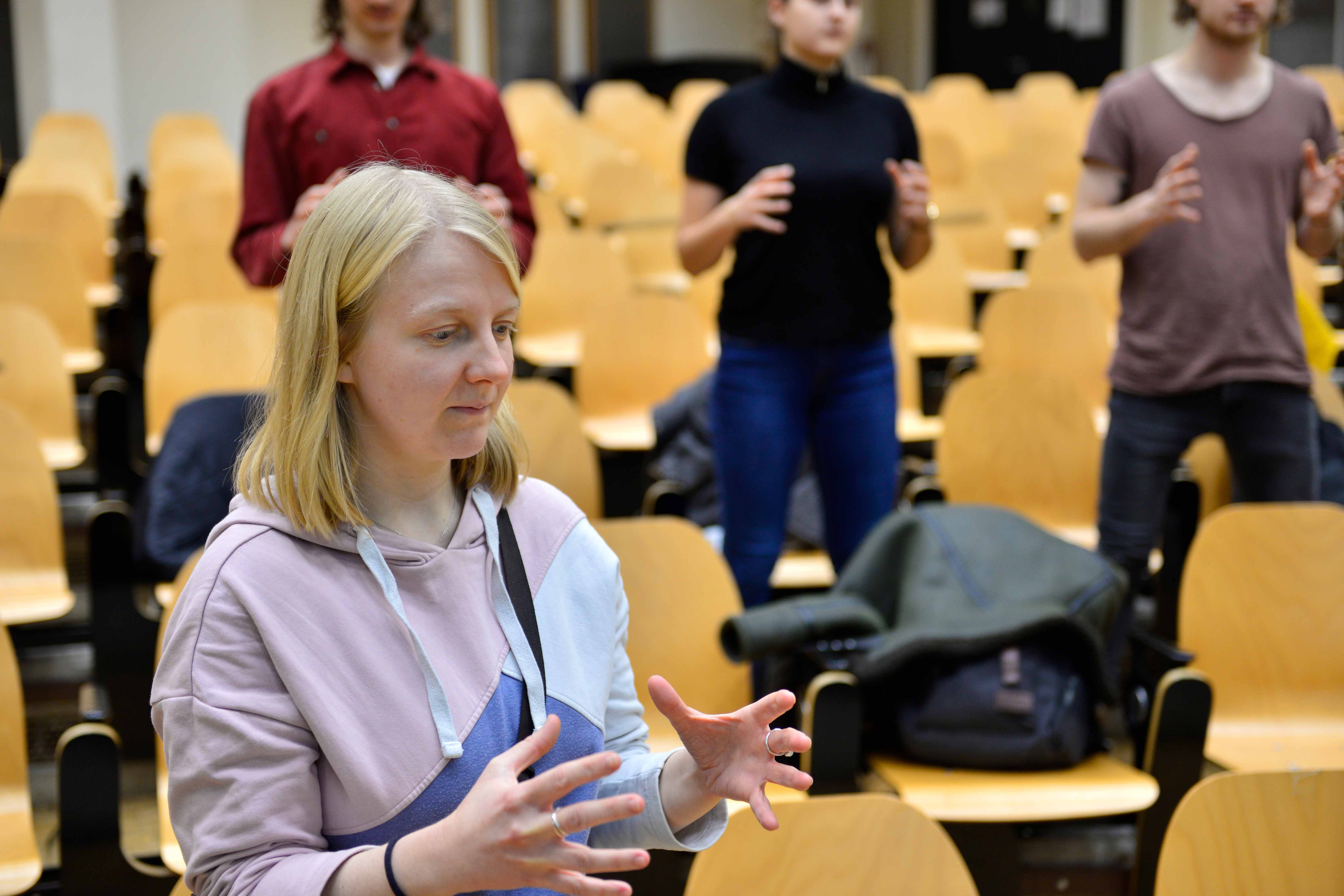 
                Student with three students in backgrounds
            