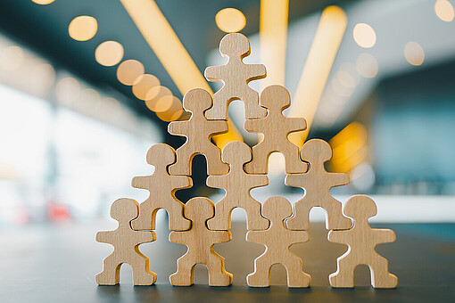 
                Holzfiguren bilden eine Pyramide
            