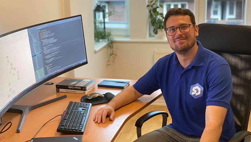 Male person at a desk 