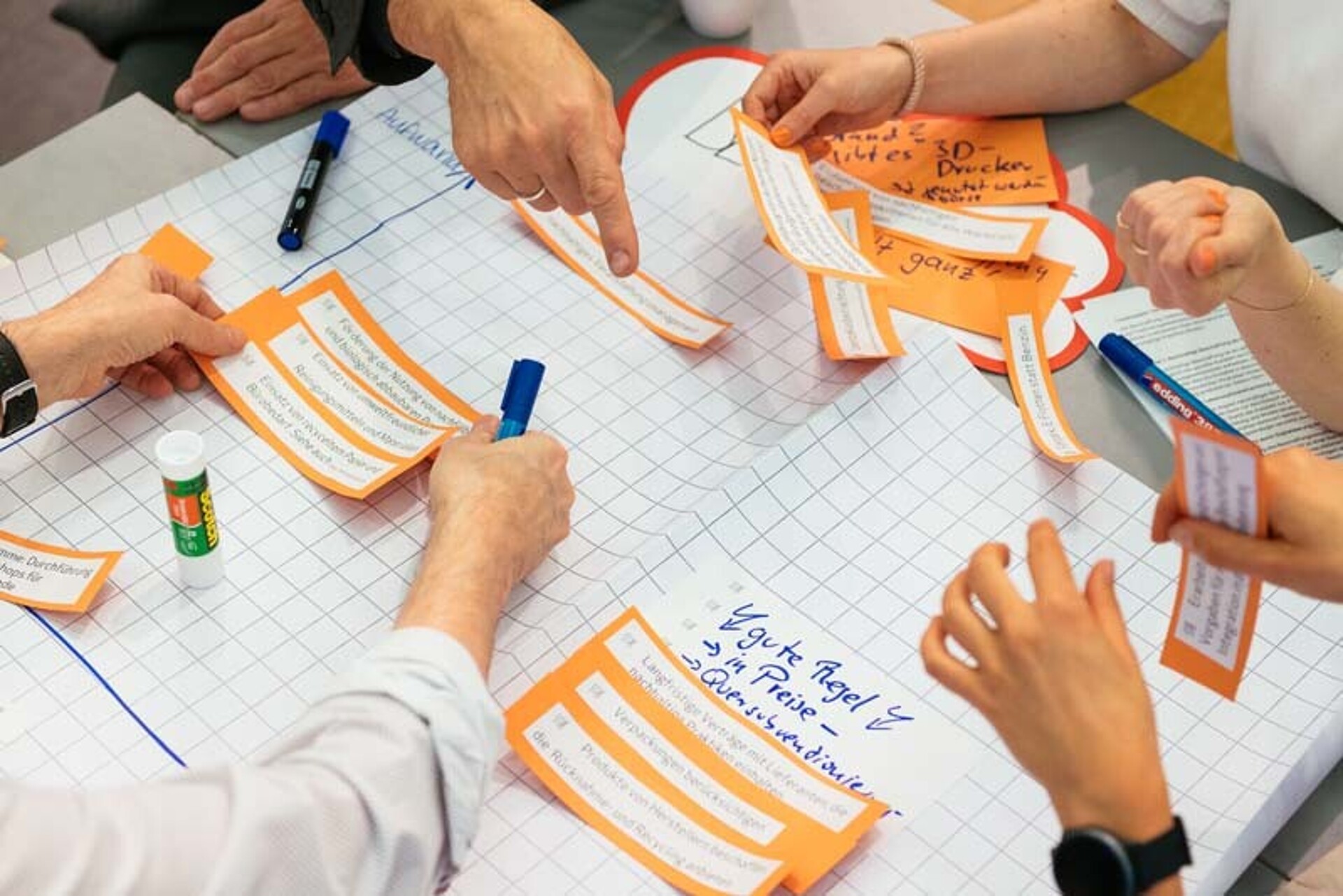 
                                                Ein Arbeitstisch zum zkh-Projekt mit Händen wird gezeigt
                                            