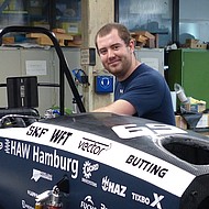 Male student working on a racing car