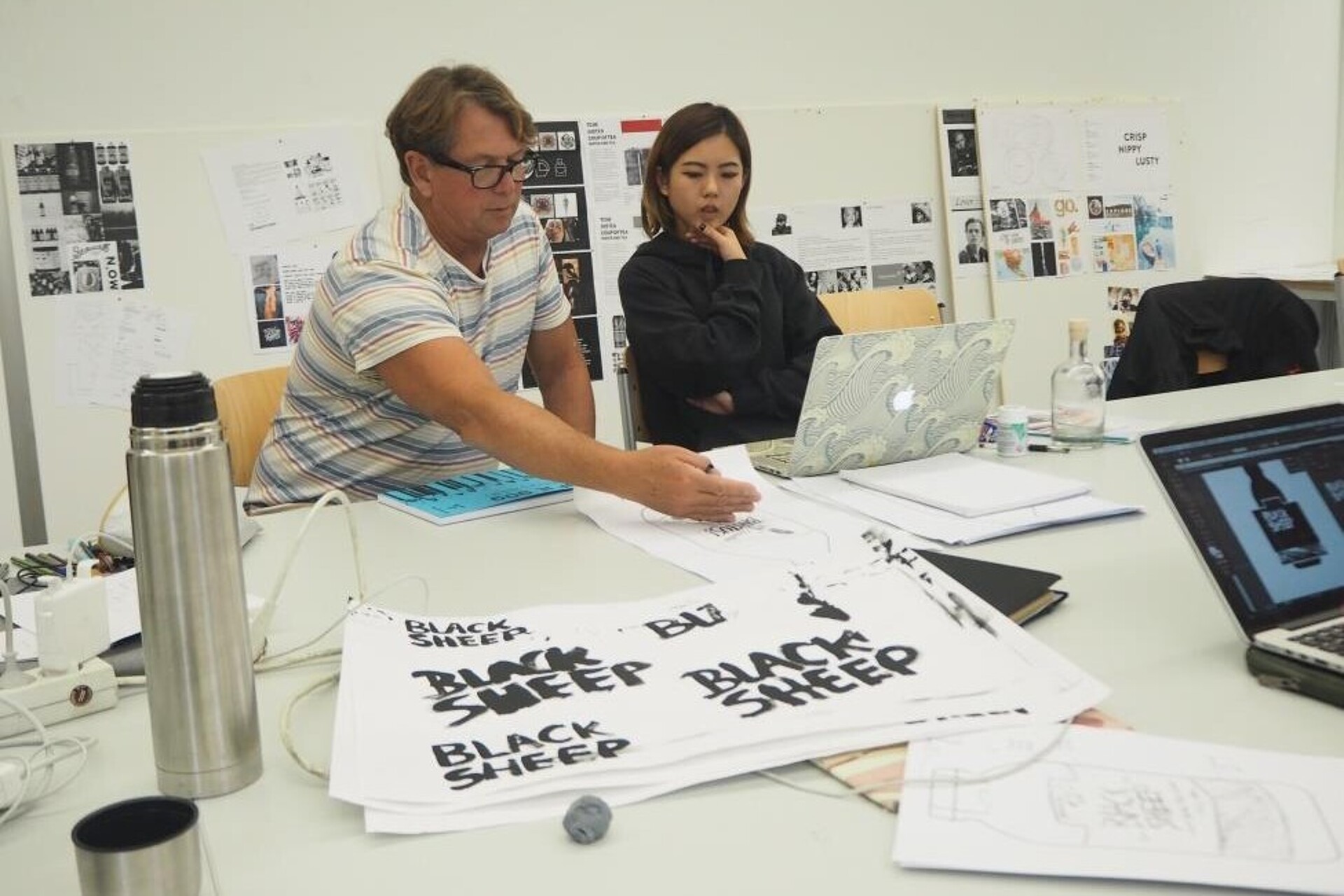 
                                                Professor with student discussing design options
                                            