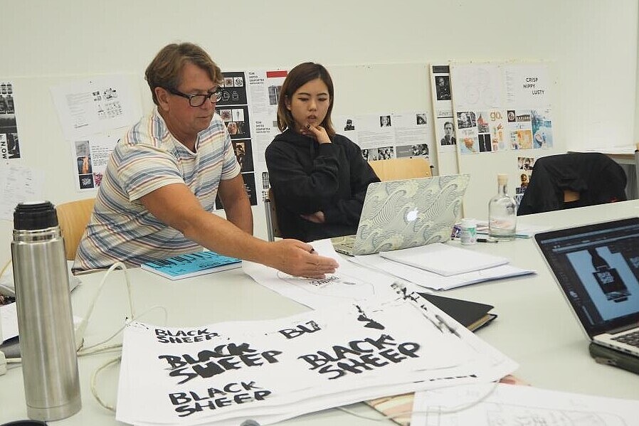 Professor with student discussing design options